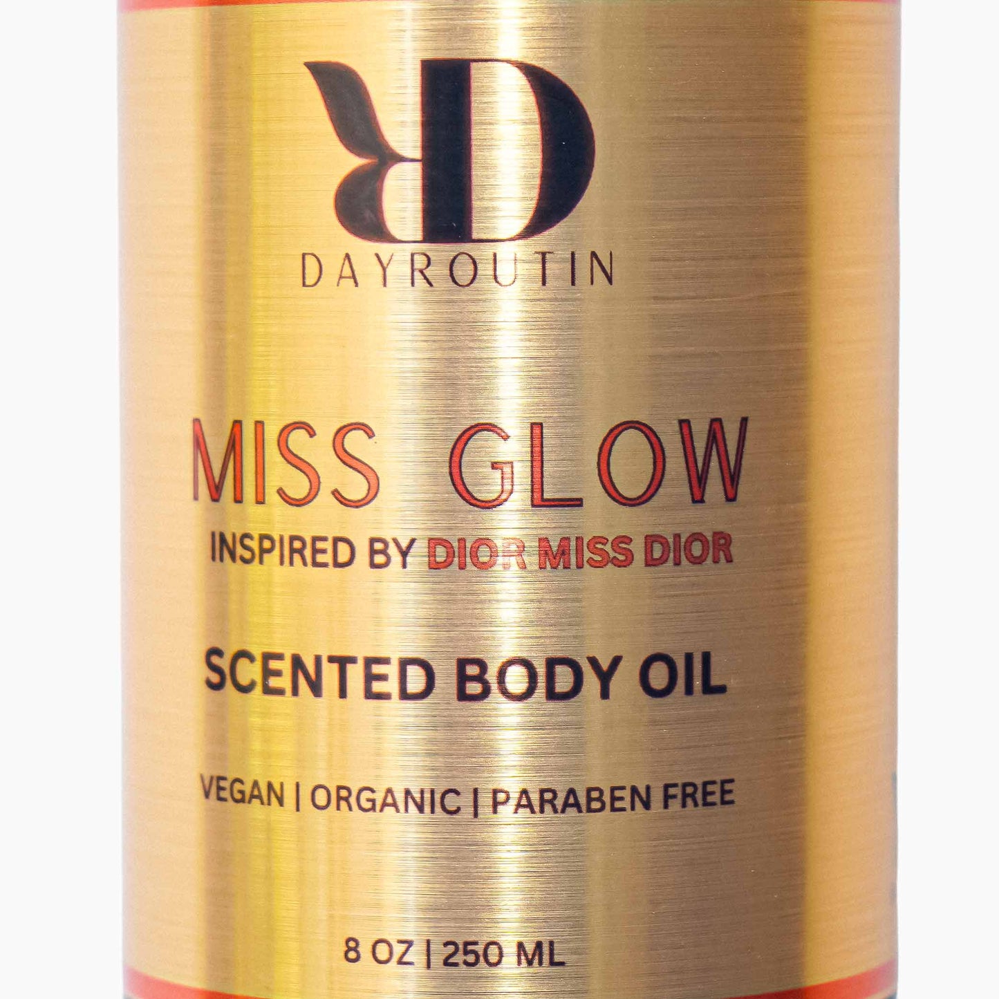 Texture shot of gold shimmer suspended in pink body oil