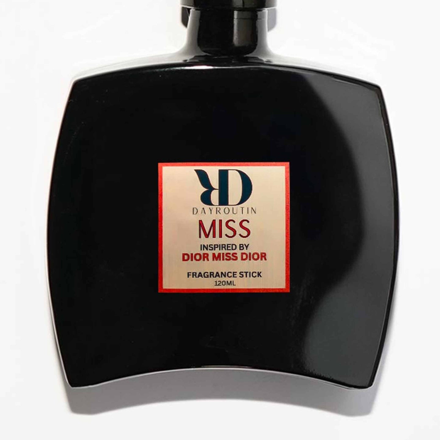 Close up of Miss Dior dupe diffuser bottle with rose flowers background