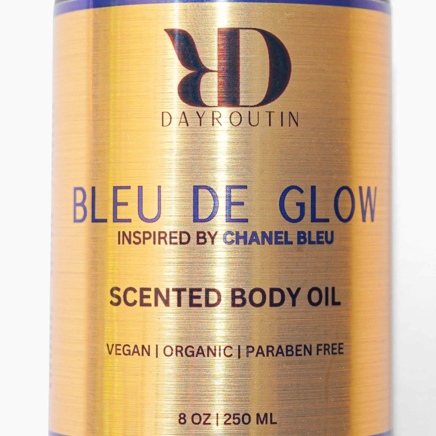 BLEU GLOW body oil on shower shelf with grooming essentials, fresh citrus woody scent