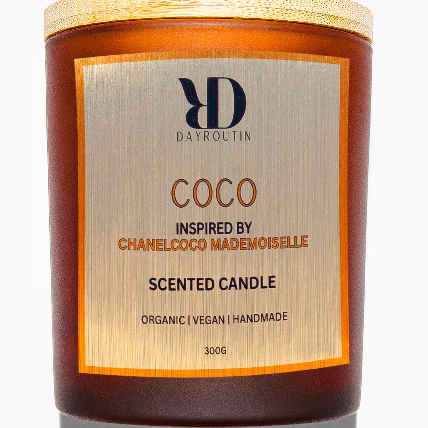 COCO candle on luxury vanity filling room with orange, rose and patchouli fragrance.
