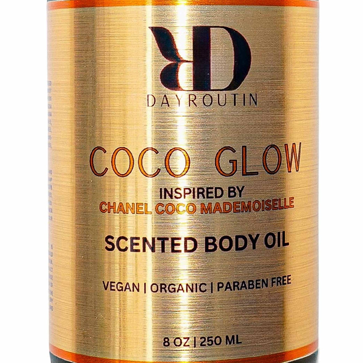COCO GLOW body oil on luxury bathroom vanity, orange rose patchouli scented radiance.