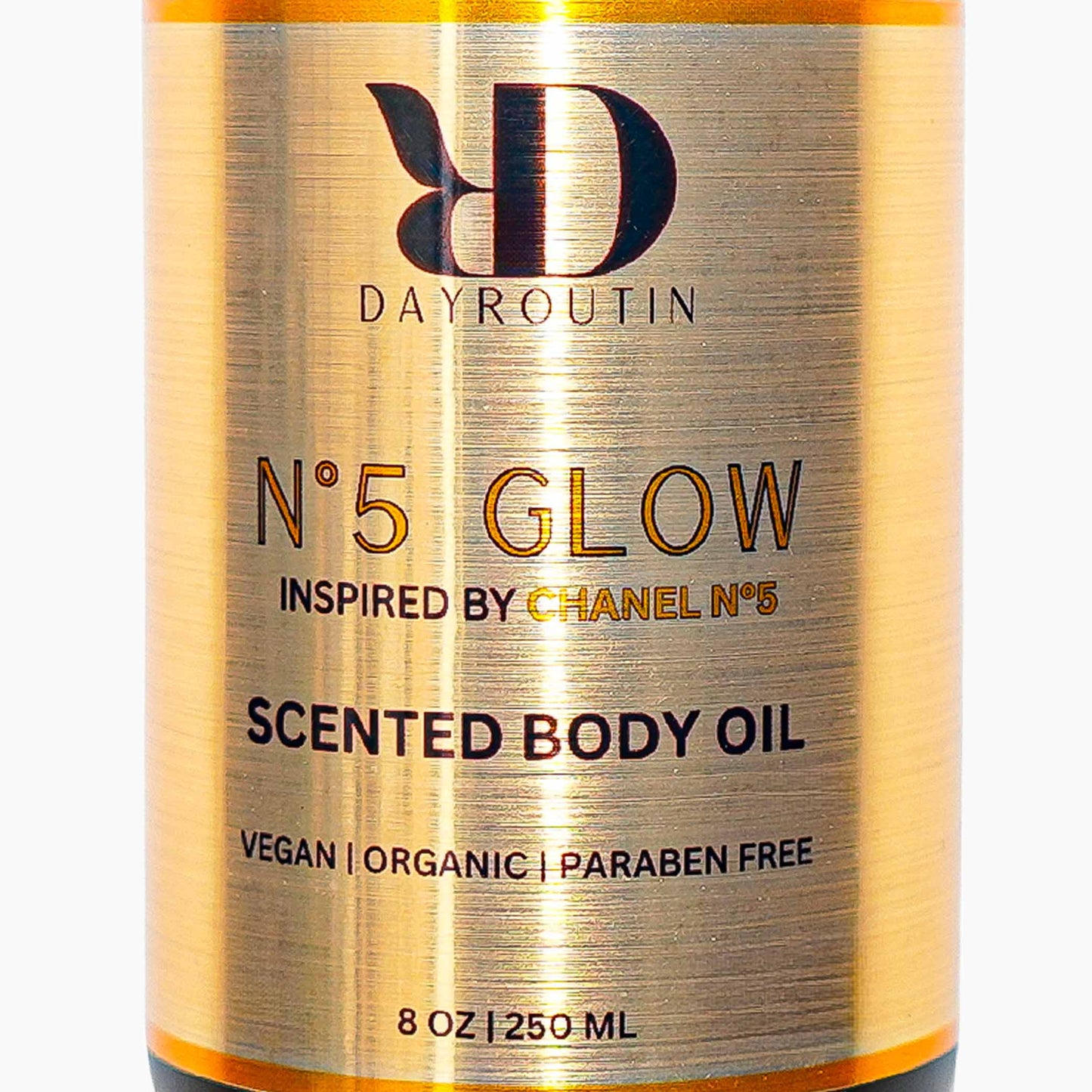N°5 GLOW body oil on a marble vanity, creating a classic powdery floral luxury ritual
